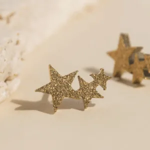 Glittery gold star-shaped earrings.